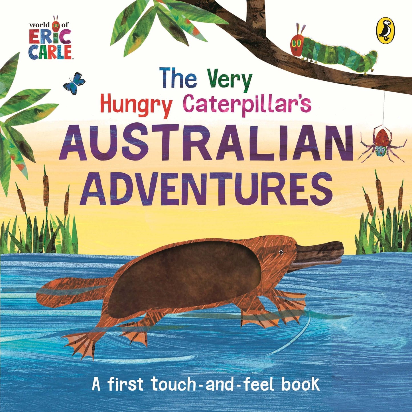 Cover of The Very Hungry Caterpillar’s Australian Adventures, a first touch-and-feel children’s book by Eric Carle, illustrated in his signature collage style, showing a brown platypus swimming in blue water with reeds, a green caterpillar on a tree branch, and a spider hanging from a thread against a yellow sunset background.