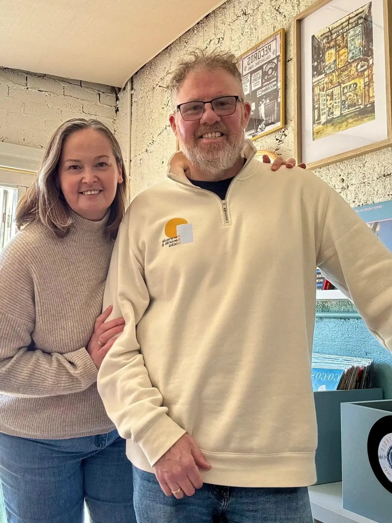 Kate and Neil Williams - co owners of Peninsula Records and Books on the Yorke Peninsula standing inside the store next to the vinyl records