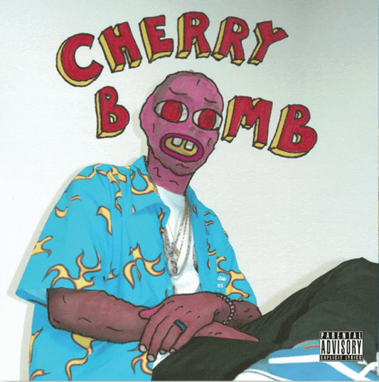 Album cover of Cherry Bomb by Tyler, the Creator, featuring a cartoon-style character with a pink mask and yellow teeth wearing a blue shirt with yellow flames, sitting under red text that reads Cherry Bomb, with a parental advisory label.