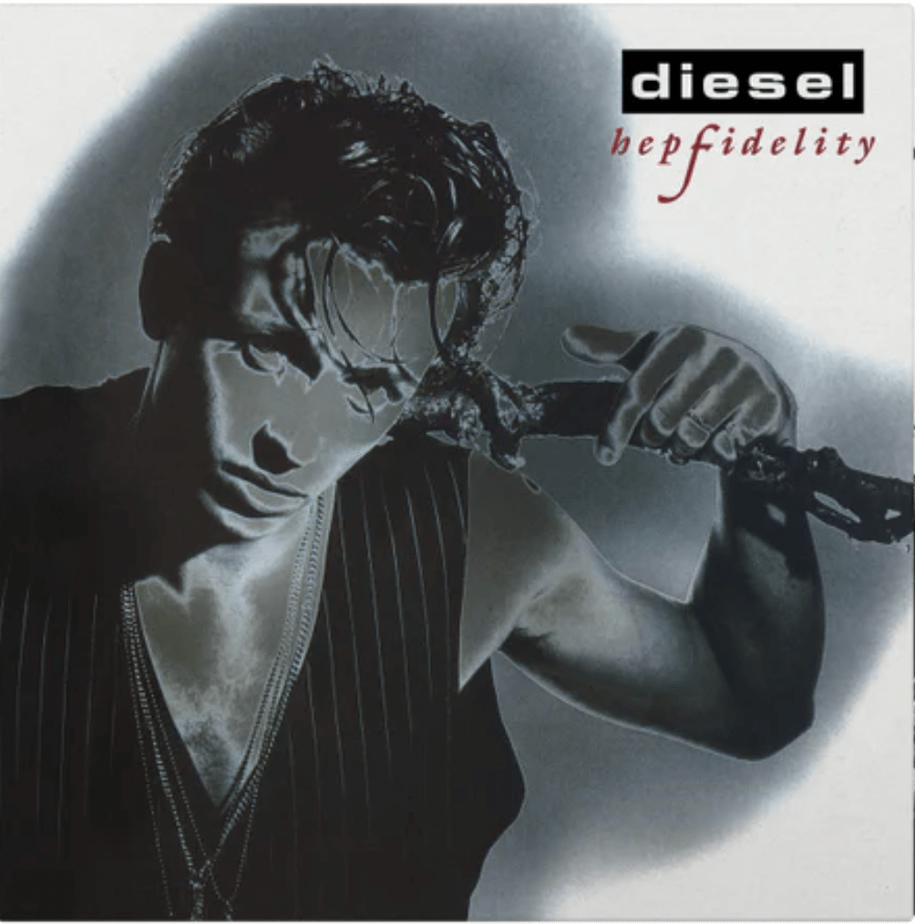 Album cover of Hepfidelity by Diesel, showing a black-and-white portrait of the artist with wet hair and layered necklaces, holding a tree branch across his shoulders, with the band name in a black box and album title in red script.