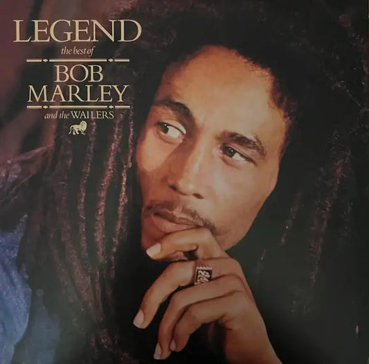 Album cover of Legend: The Best of Bob Marley and the Wailers, featuring a close-up portrait of Bob Marley with dreadlocks, resting his chin on his hand and wearing a ring, with gold serif text in the top left corner.