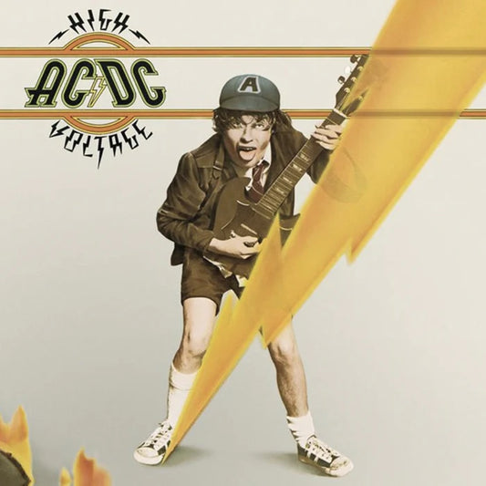AC/DC – High Voltage album cover featuring Angus Young in school uniform with guitar and a yellow lightning bolt graphic; 1975 rock classic.