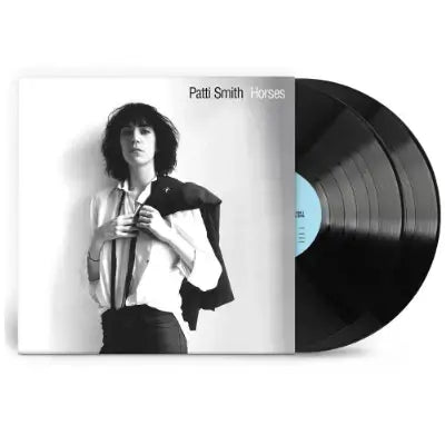 Vinyl record with Patti Smith album cover featuring a black and white photo of the artist. And two black vinyl lp peeking out the of vinyl cover