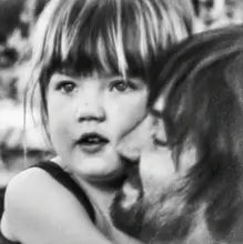 Album cover for Tame Impala Deadbeat vinyl record depicting a Black and white photo of a child being held by an adult