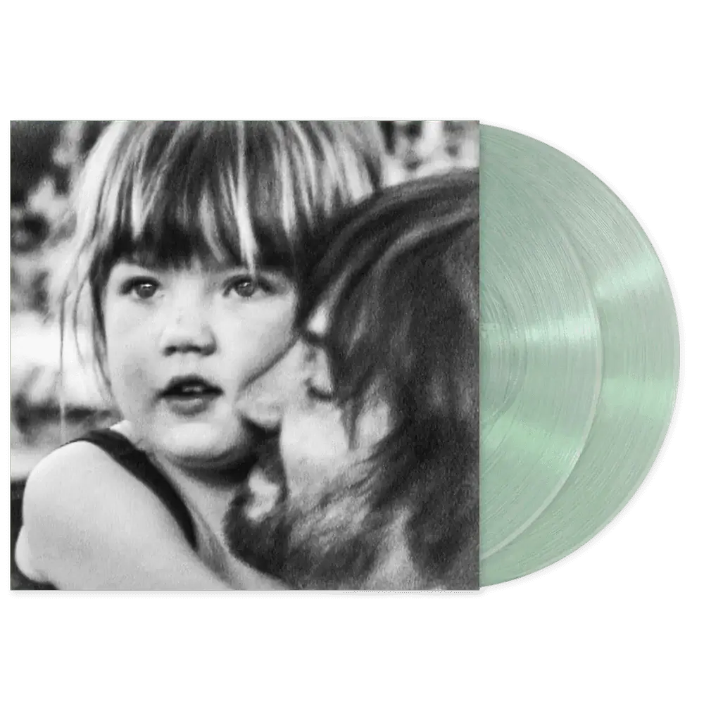 Tame Impala latest album.. Vinyl record with a black and white photo of a child on the cover and two coke bottle green vinyl lp