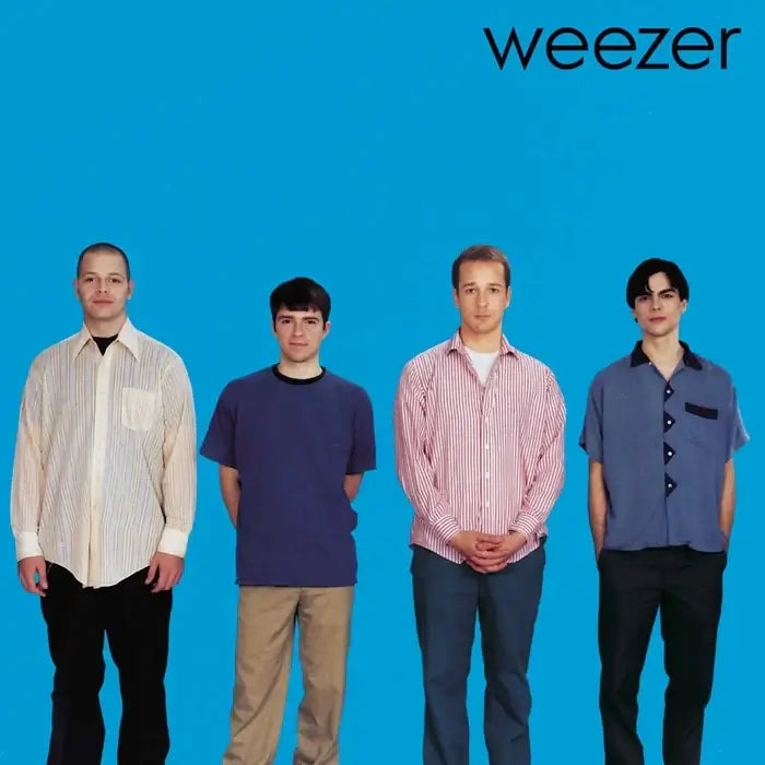 Weezer – Weezer (Blue Album) cover: four band members standing against a solid blue background; minimalist 1994 alt-rock classic.